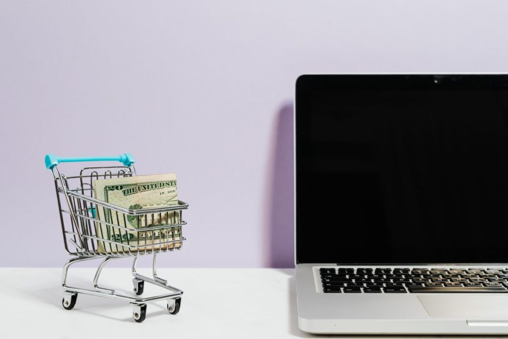 Shopping cart next to laptop symbolizing ecommerce conversion optimization