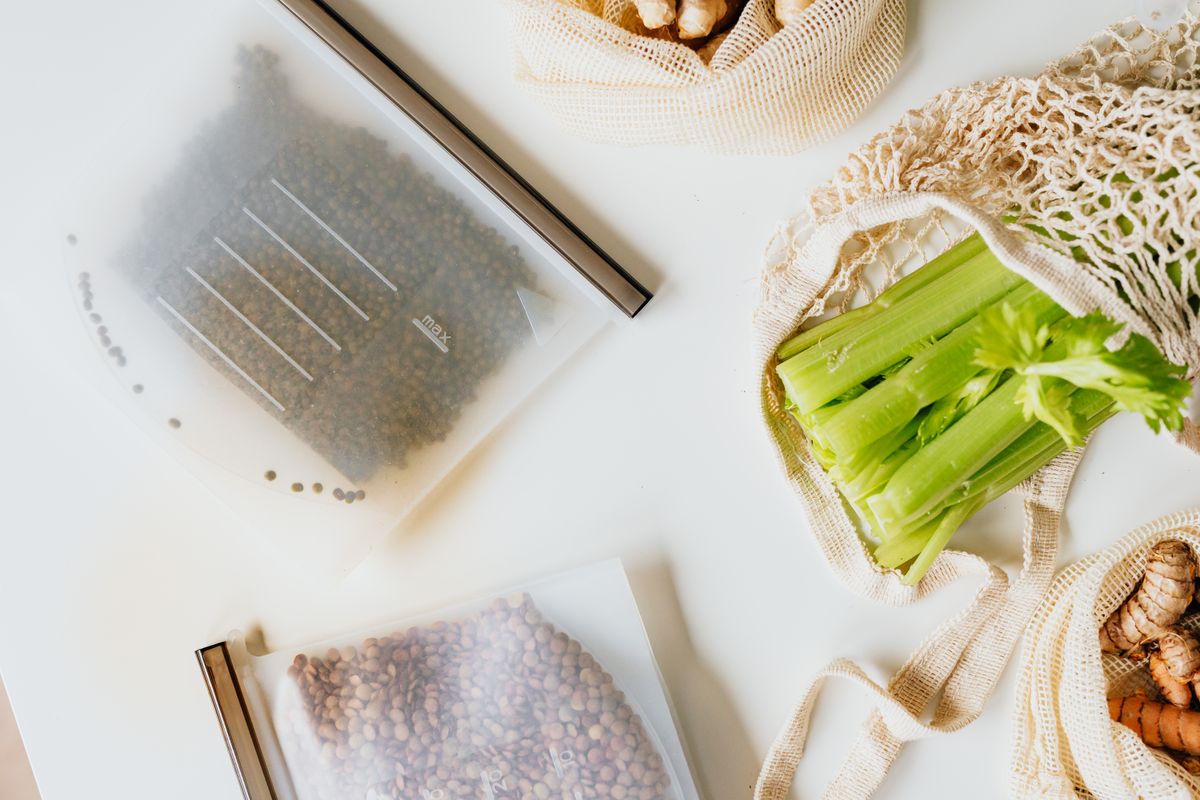 Zip lock bags beside celery for food storage and sous vide preparation in commercial kitchen