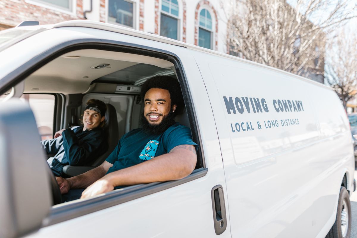 Professional movers with moving truck ready for relocation
