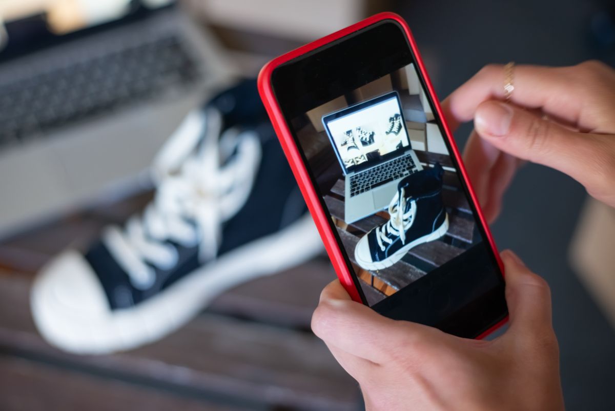 Person taking photo of shoes for ecommerce product listing and Amazon FBA optimization