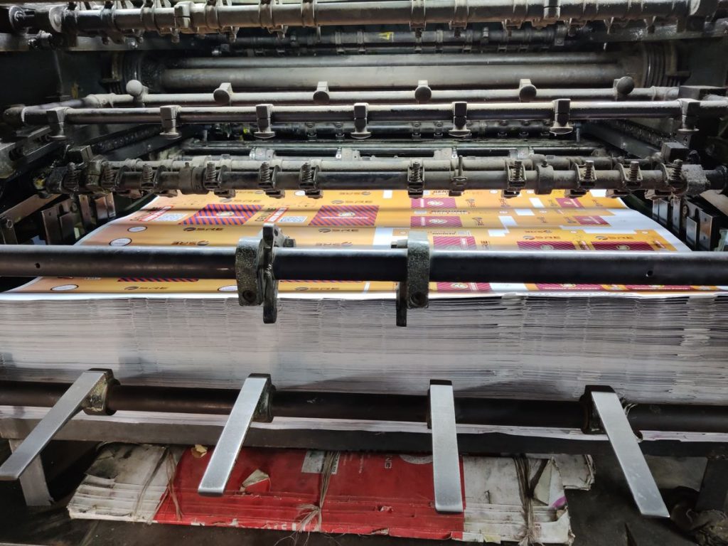 Industrial printing machine processing sheets in factory