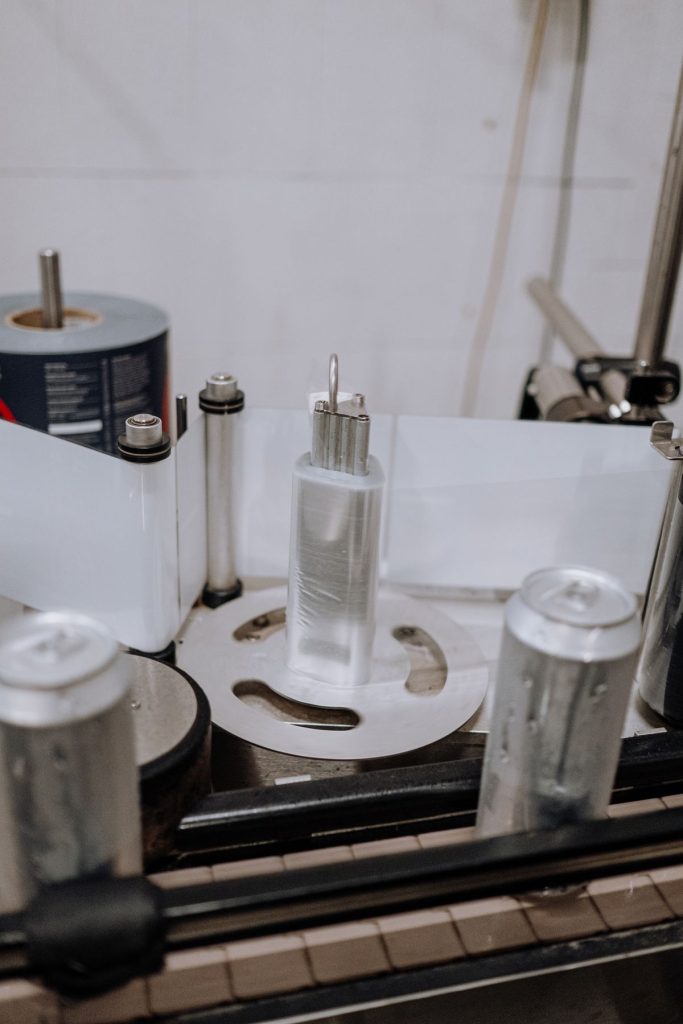 Automated labeling system in modern factory demonstrating color consistency in packaging manufacturing