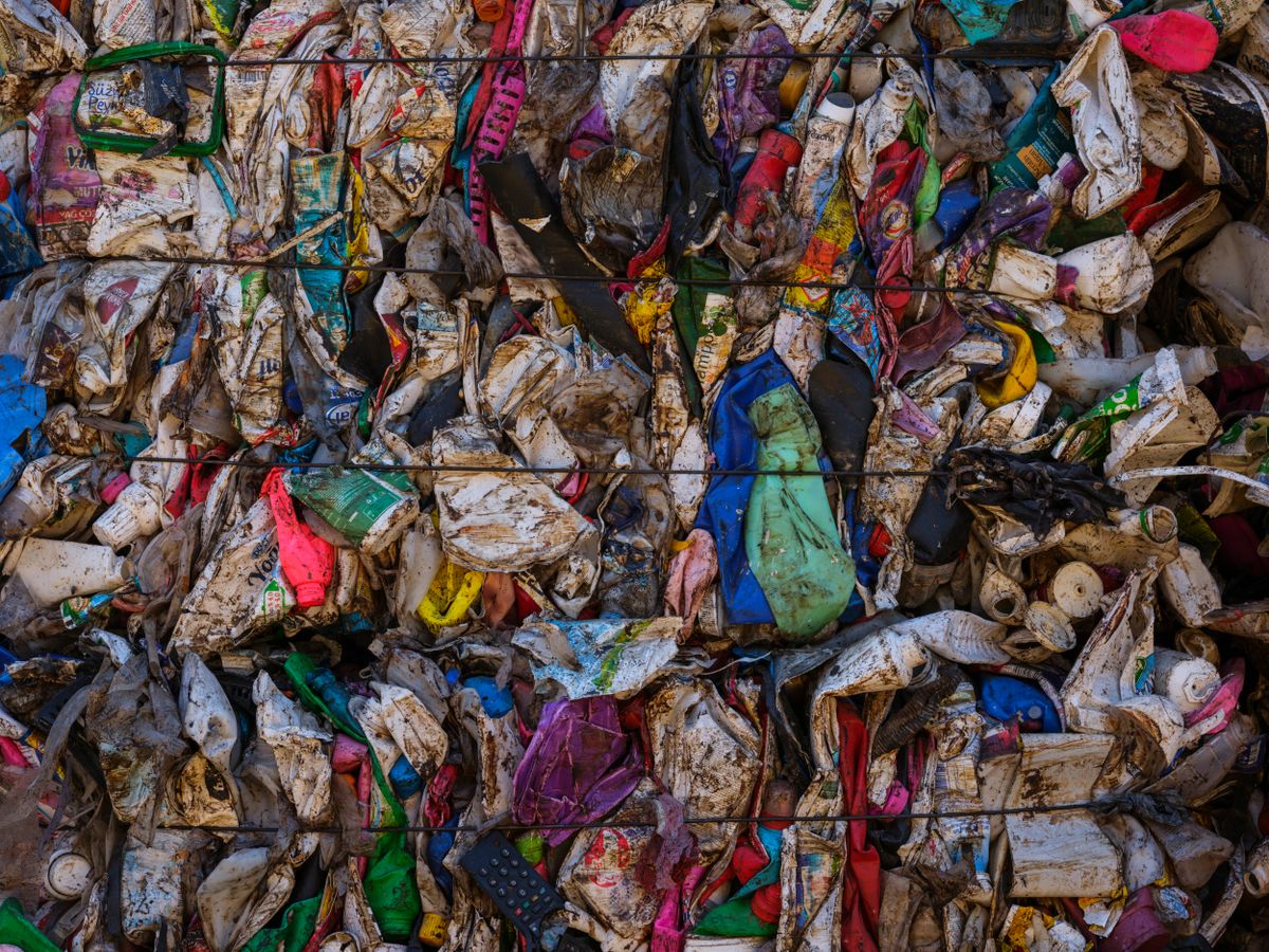 Compressed plastic waste at recycling center representing EU packaging compliance