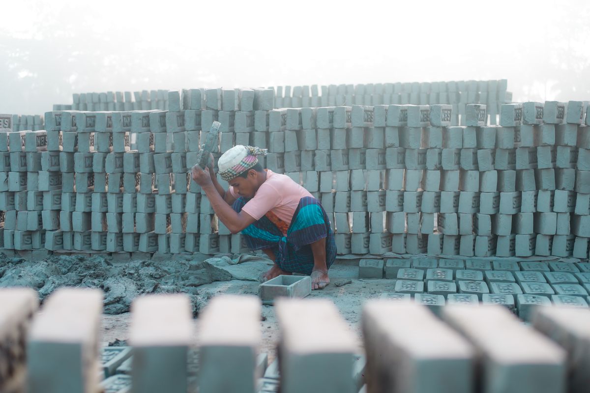 Manufacturing factory quality control worker inspecting production line