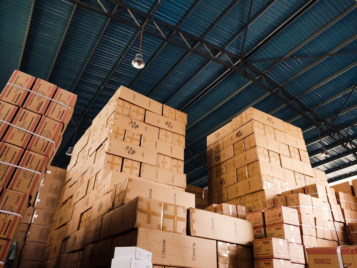 Stacked boxes in warehouse representing B2B warranty logistics for vacuum bag importers