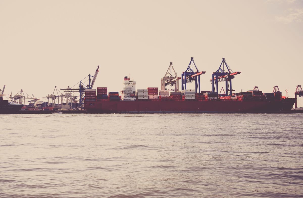 Cargo ship loaded with shipping containers at port for vacuum storage bag imports