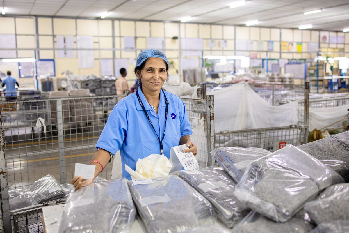 Factory worker quality inspecting vacuum storage bag production